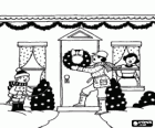 Familia decorando la entrada de su casa para la Navidad