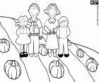 Una familia en el campo durante el otoño con la cosecha de calabazas
