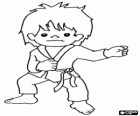Niño practicando artes marciales, entrenando karate con el uniforme karategi: chaqueta o kimono, pantalones  y cinturón